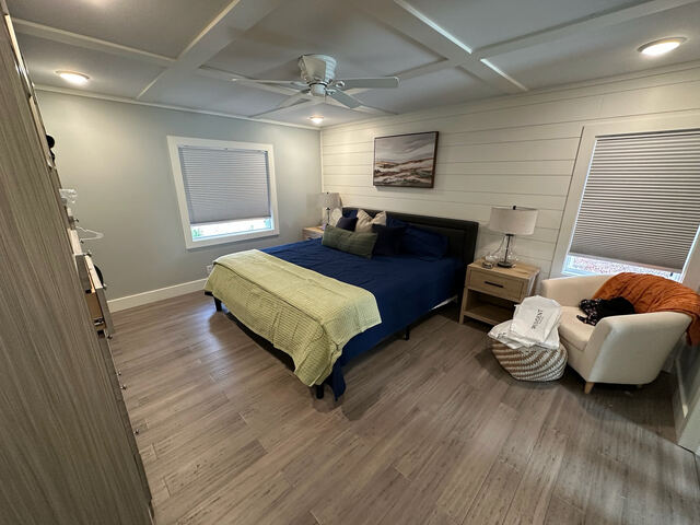 Bedroom with wood floors and reading chair