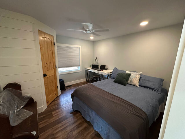 Bedroom with barn door and wood floors