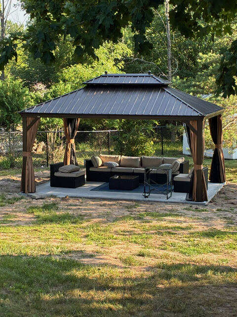 Covered gazebo with outdoor lounge furniture
