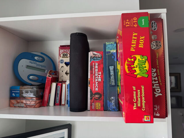 Shelf of board games for guest use
